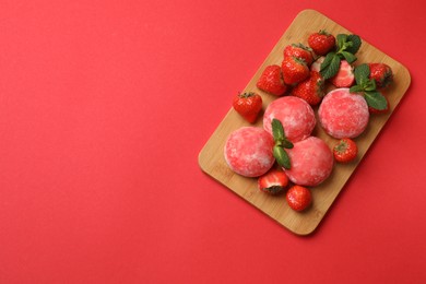 Photo of Delicious mochi, strawberries and mint on red background, top view. Space for text