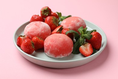 Photo of Delicious mochi, strawberries and mint on pink background, closeup