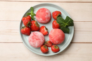 Photo of Delicious mochi, strawberries and mint on wooden table, top view