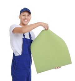 Young decorator with roll of wallpaper on white background