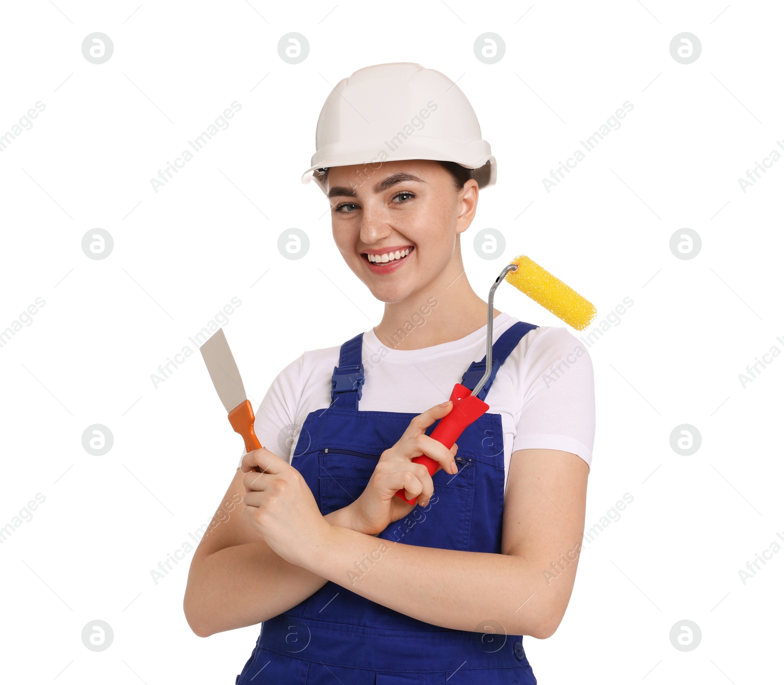 Photo of Portrait of young decorator with paint roller and putty knife on white background