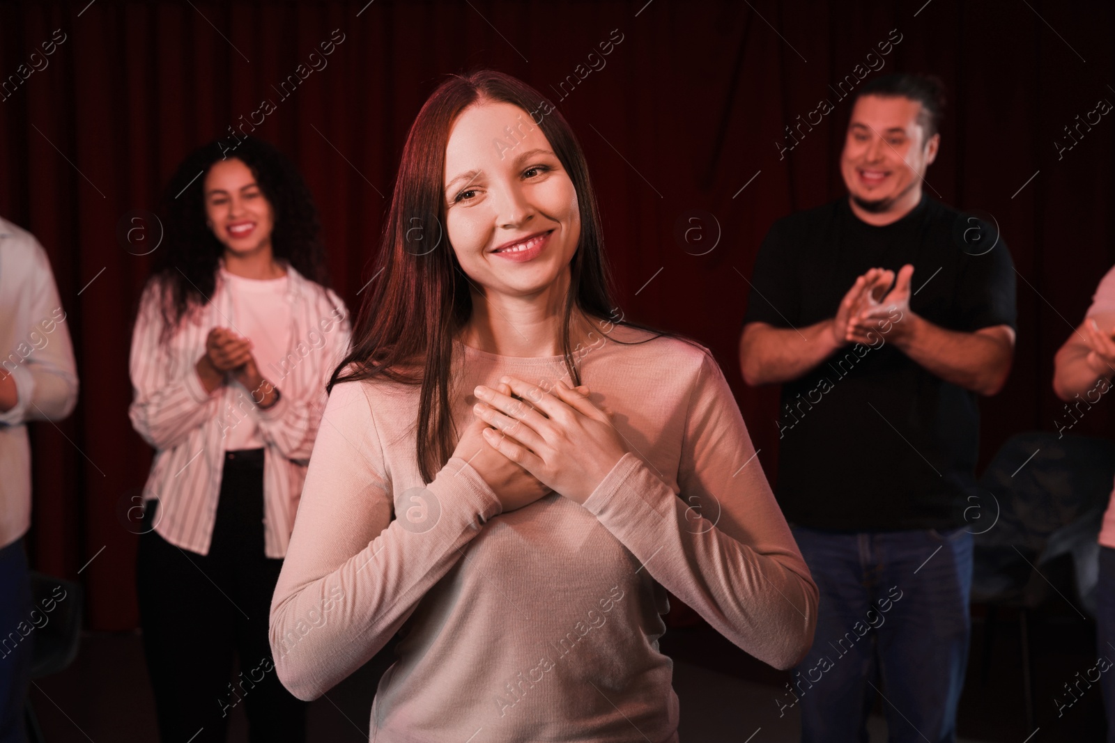 Photo of Professional actors bowing on stage in theatre