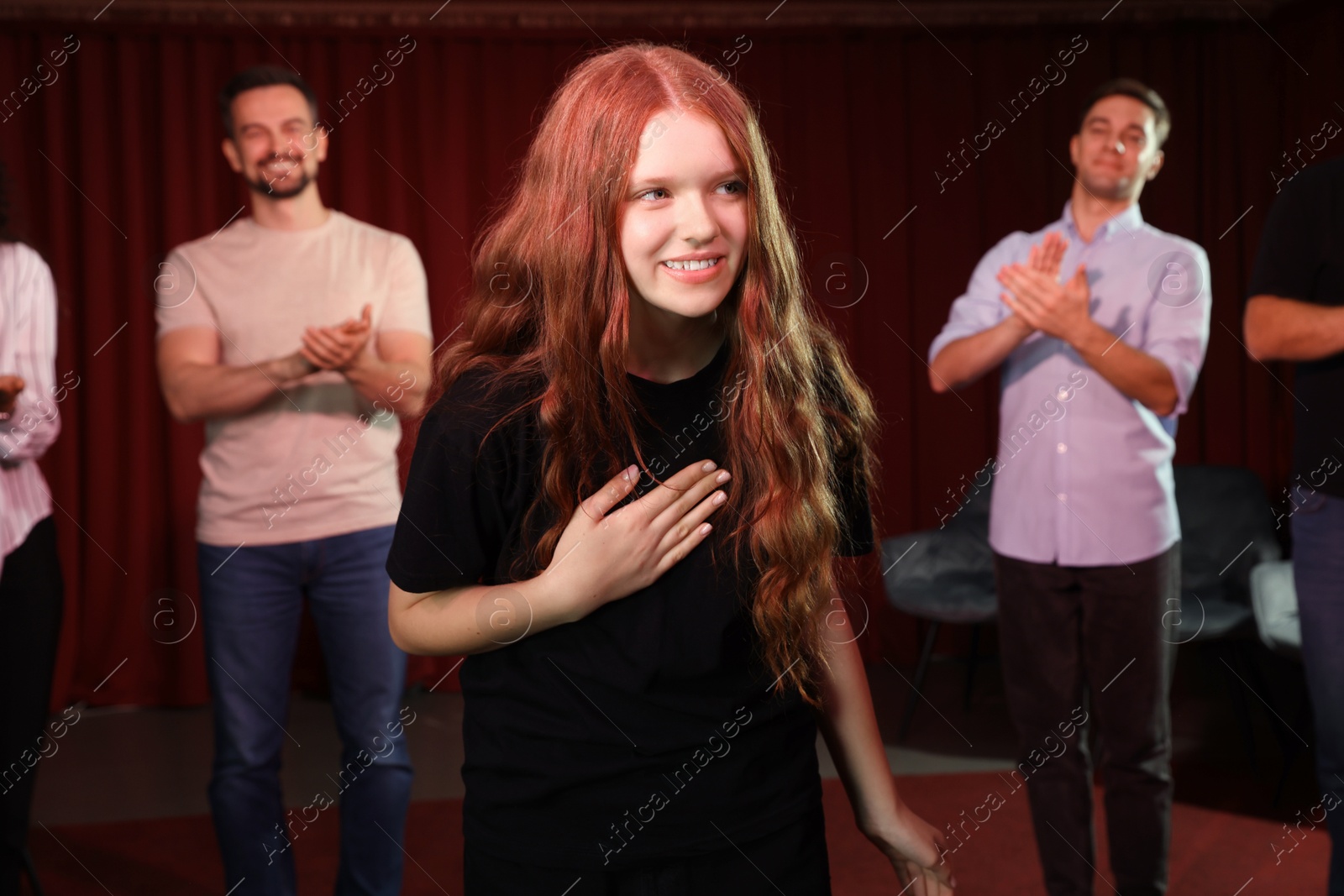 Photo of Professional actors bowing on stage in theatre