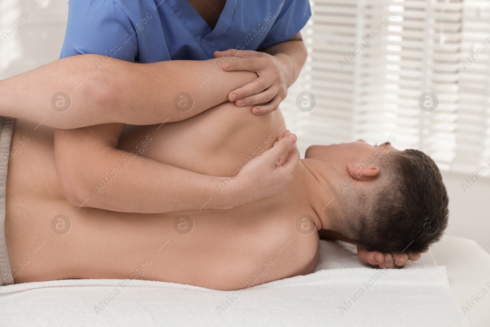 Photo of Osteopath working with patient in clinic, closeup. Manual therapy