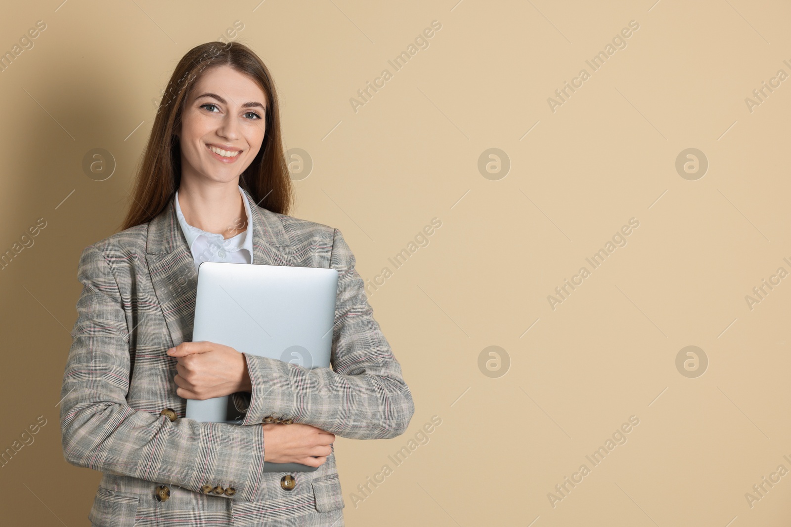 Photo of Portrait of smiling banker with laptop on beige background. Space for text