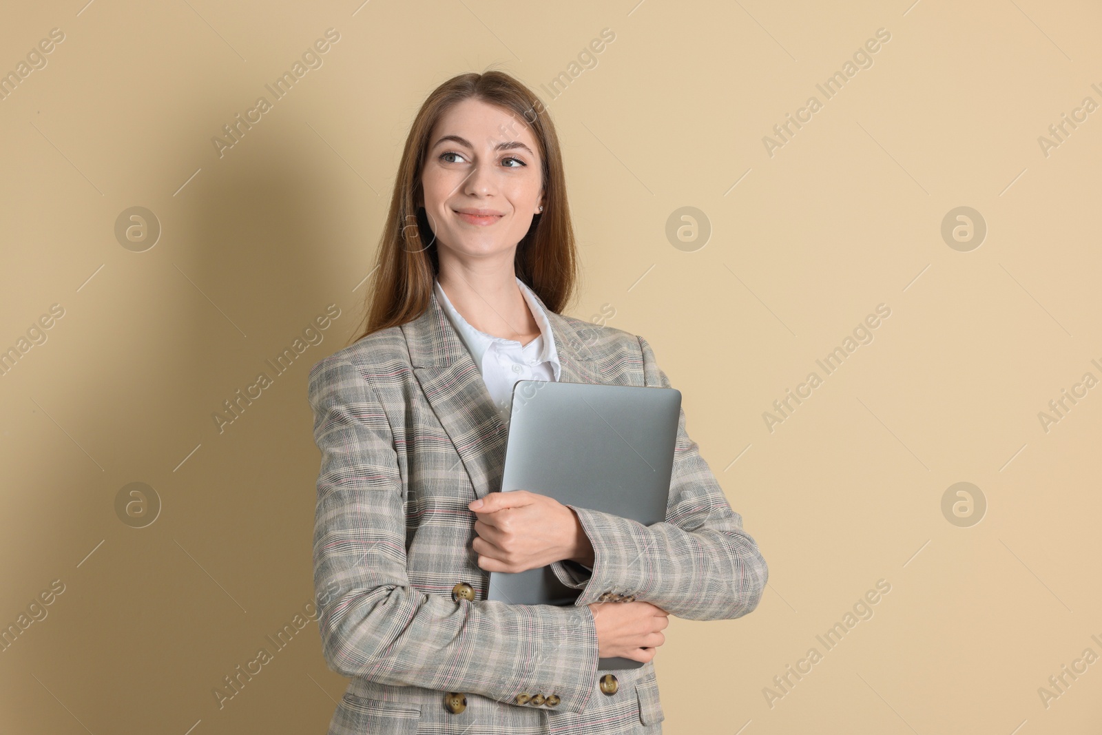 Photo of Portrait of smiling banker with laptop on beige background