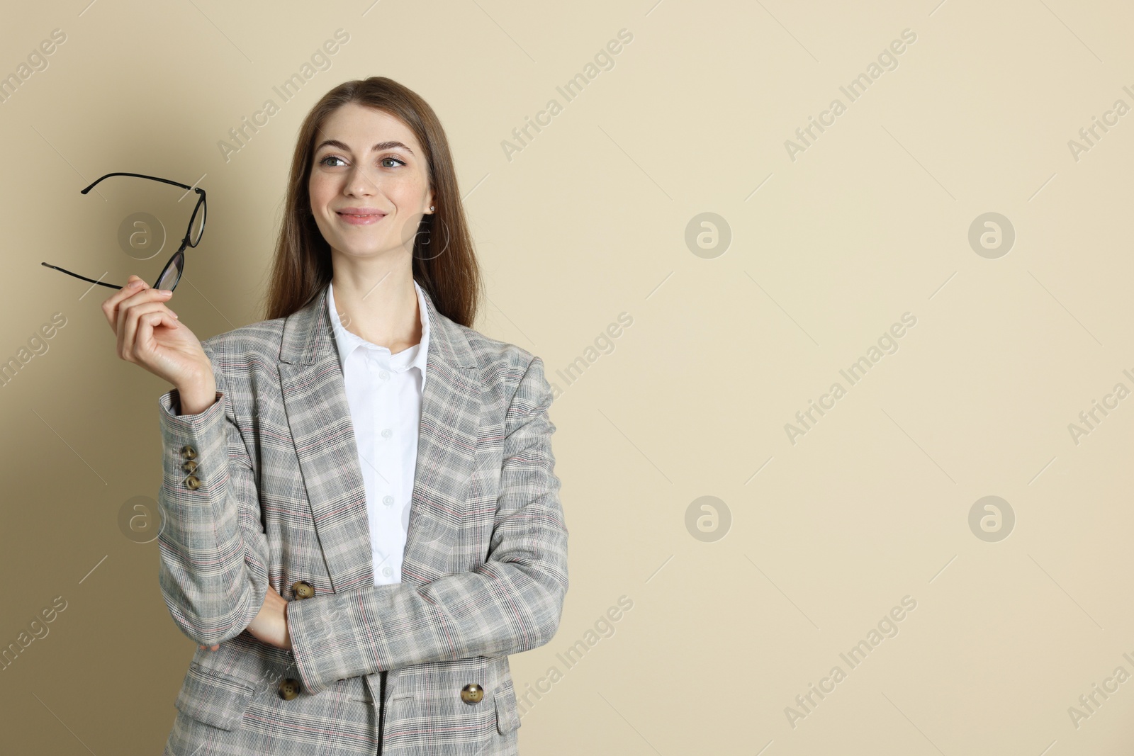 Photo of Portrait of smiling banker on beige background. Space for text