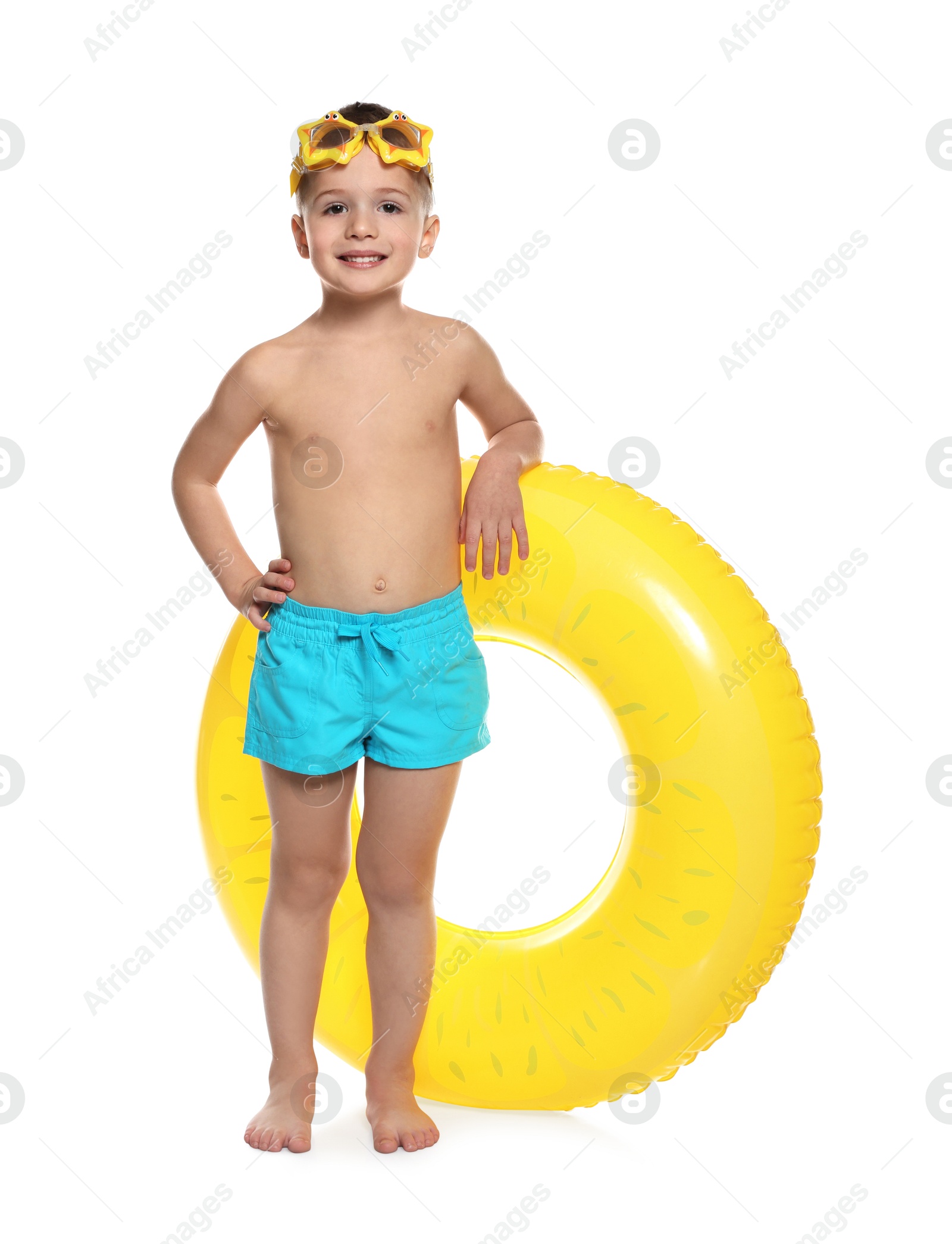 Photo of Cute little boy in beachwear with diving mask and inflatable ring on white background