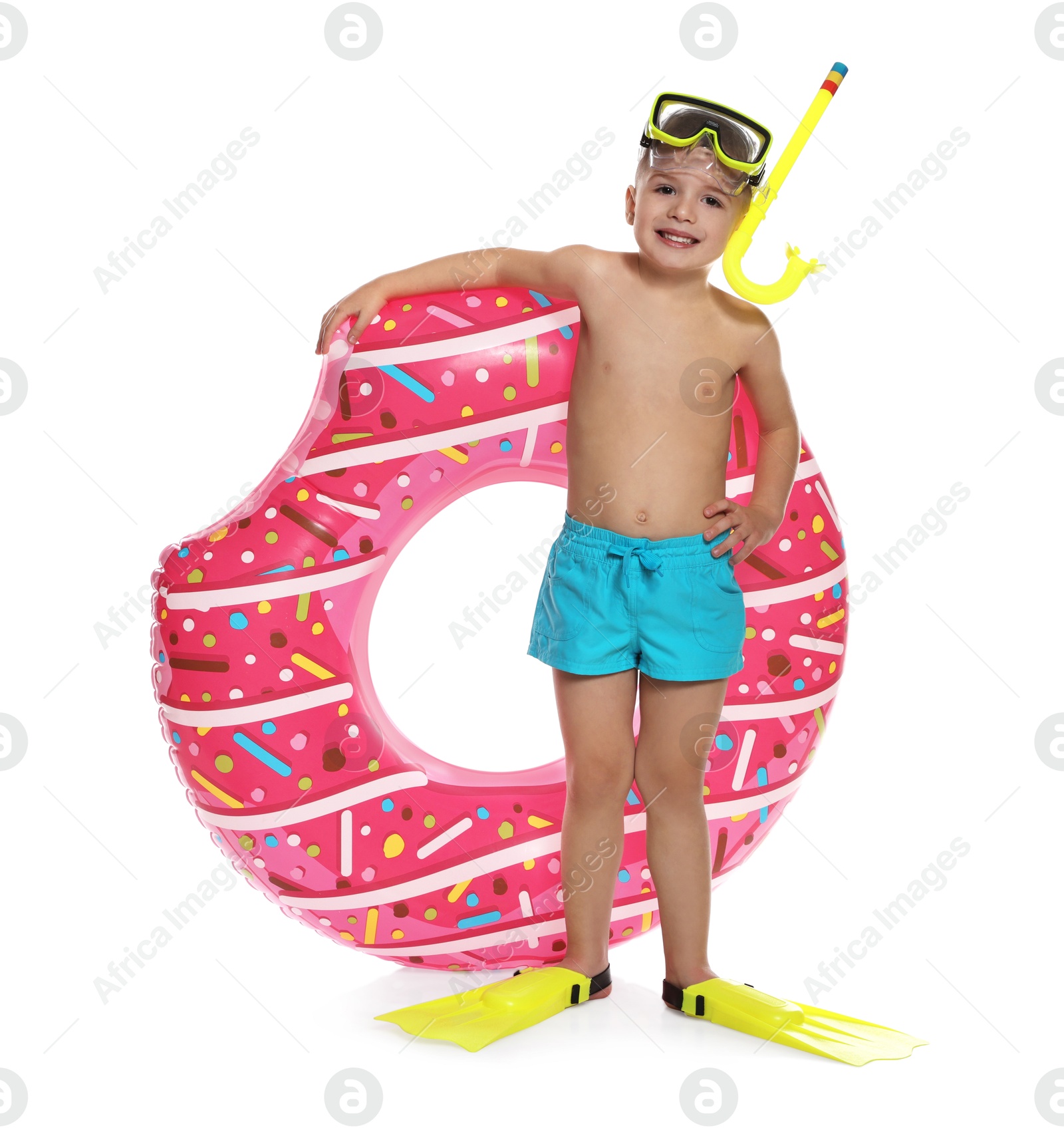 Photo of Cute little boy in beachwear with snorkeling equipment and inflatable ring on white background