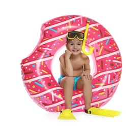 Photo of Cute little boy in beachwear with snorkeling equipment and inflatable ring on white background