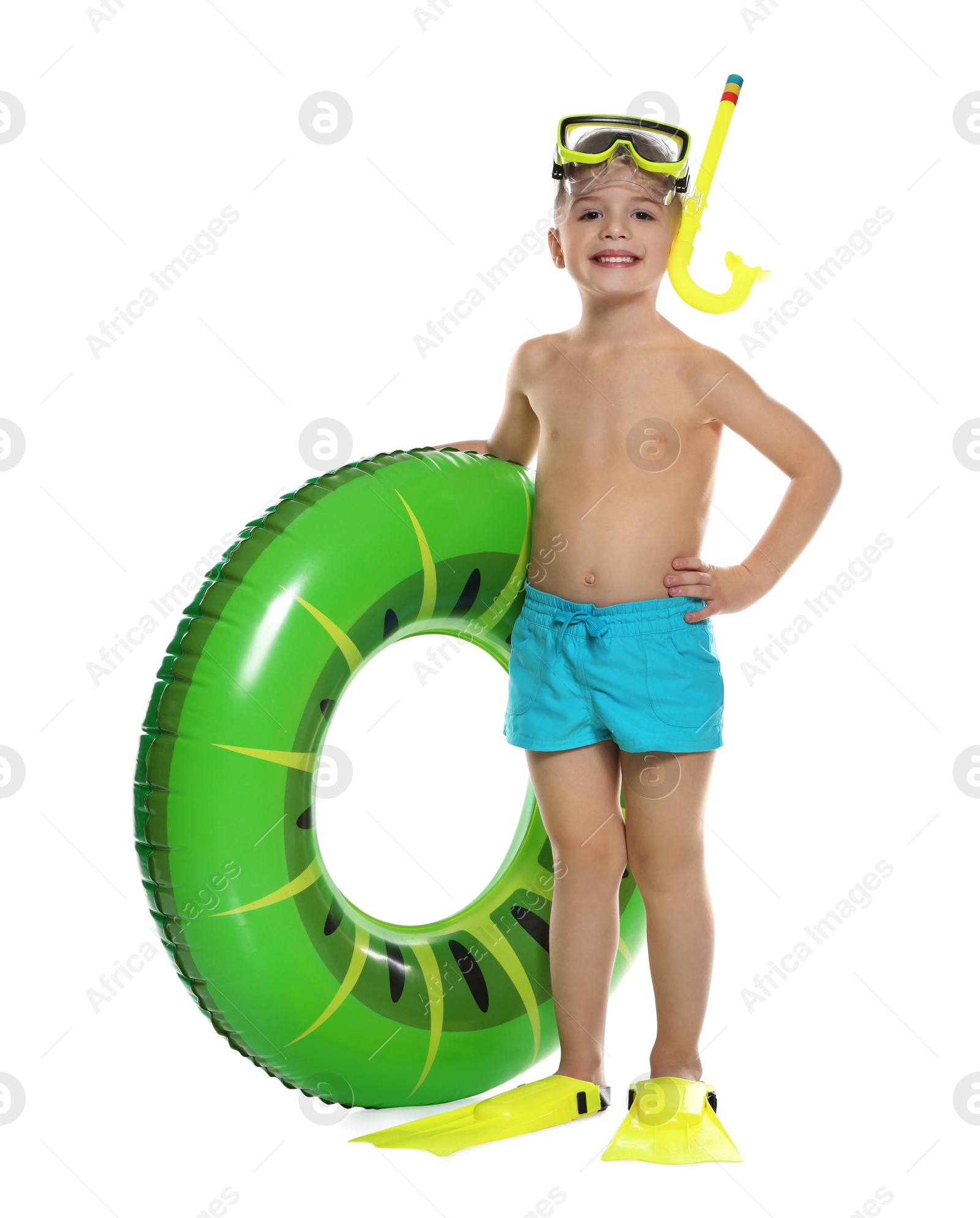 Photo of Cute little boy in beachwear with snorkeling equipment and inflatable ring on white background