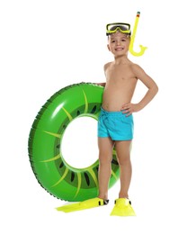 Photo of Cute little boy in beachwear with snorkeling equipment and inflatable ring on white background