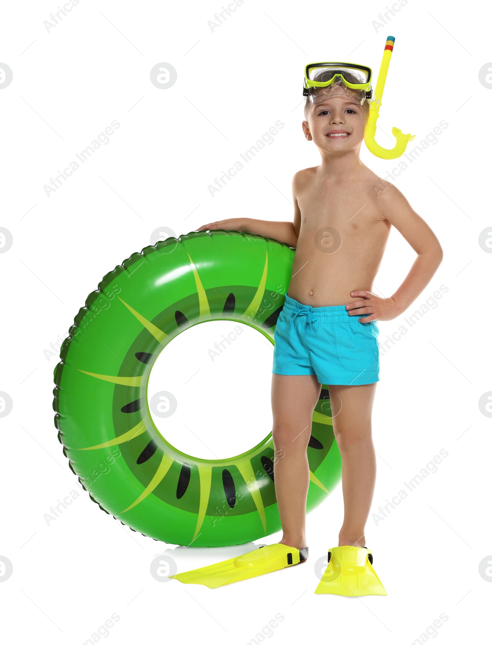 Photo of Cute little boy in beachwear with snorkeling equipment and inflatable ring on white background