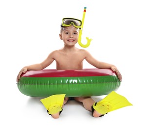 Photo of Cute little boy in beachwear with snorkeling equipment and inflatable ring on white background