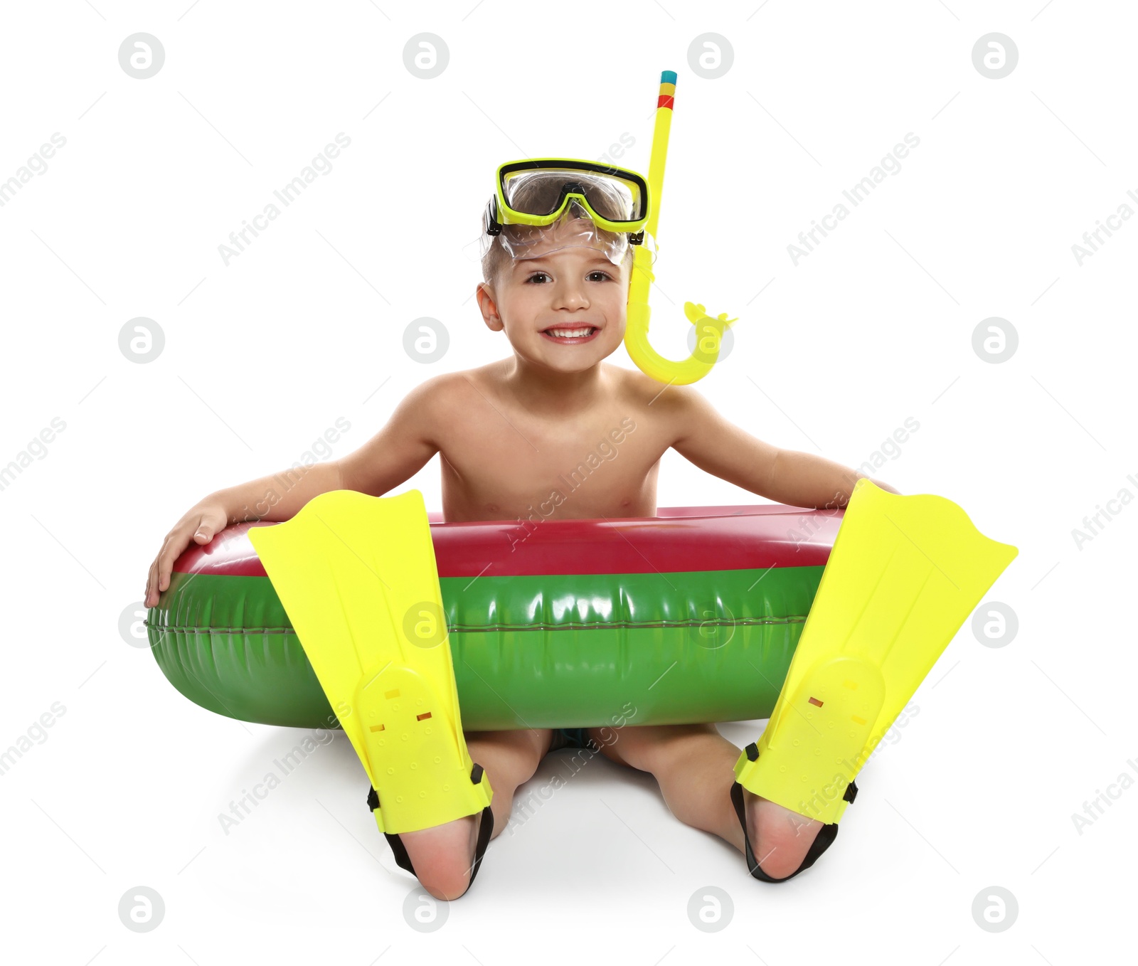 Photo of Cute little boy in beachwear with snorkeling equipment and inflatable ring on white background