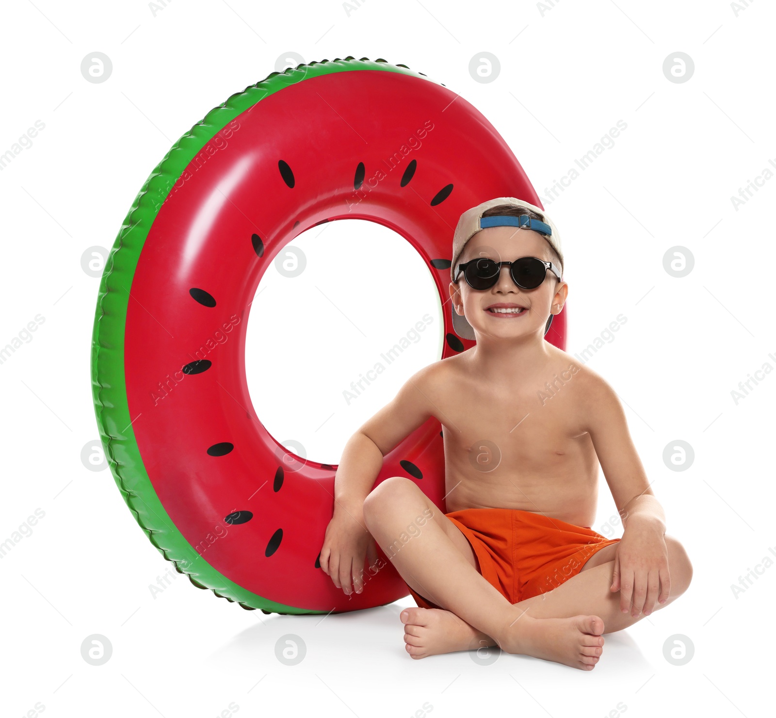 Photo of Cute little boy in beachwear with inflatable ring on white background