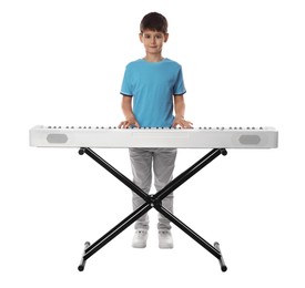 Cute boy playing synthesizer on white background