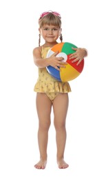 Cute little girl in swimsuit with inflatable ball and swim goggles on white background