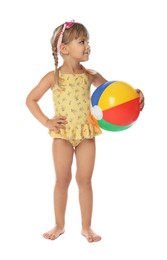 Photo of Cute little girl in swimsuit with inflatable ball and swim goggles on white background