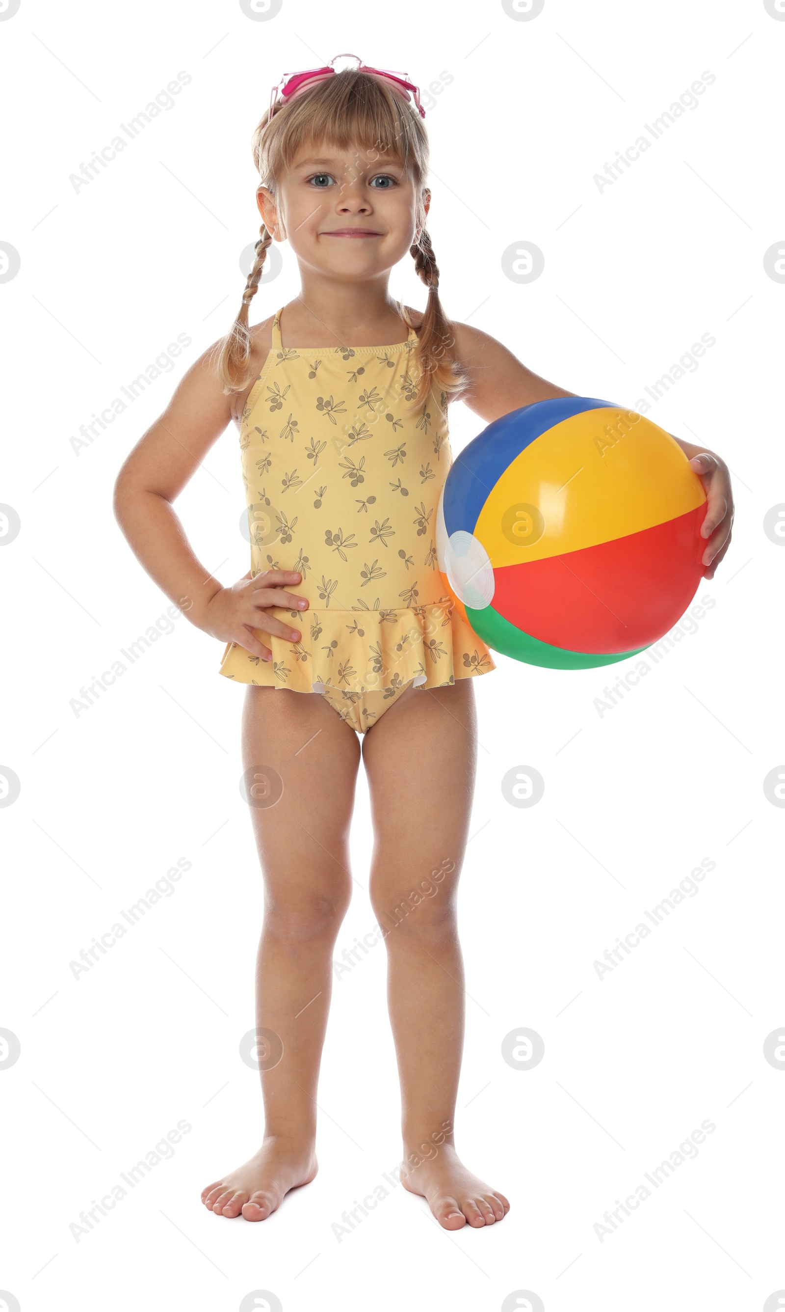 Photo of Cute little girl in swimsuit with inflatable ball and swim goggles on white background