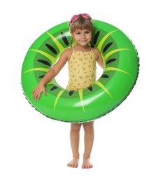 Photo of Cute little girl in swimsuit with inflatable ring and swim goggles on white background