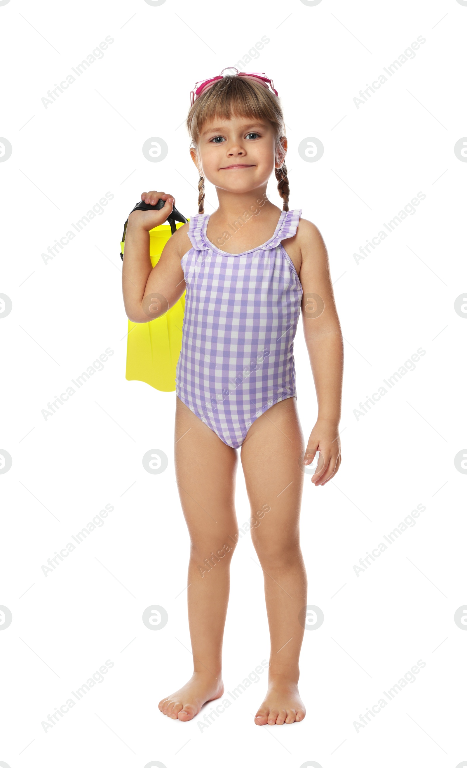 Photo of Cute little girl in swimsuit with flippers and swim goggles on white background