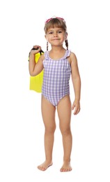 Cute little girl in swimsuit with flippers and swim goggles on white background