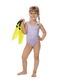 Photo of Cute little girl in swimsuit with flippers and swim goggles on white background