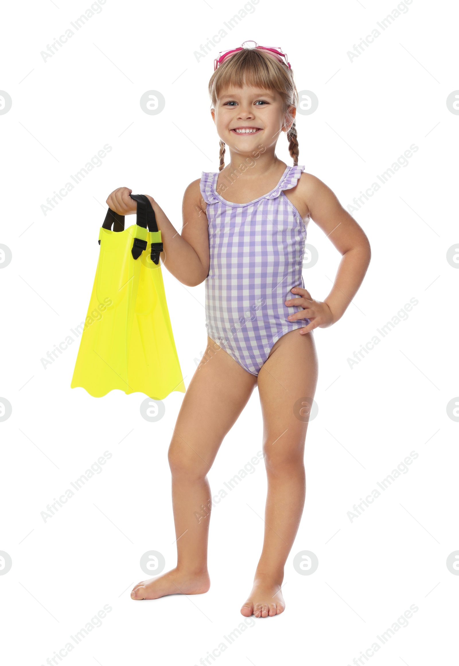 Photo of Cute little girl in swimsuit with flippers and swim goggles on white background