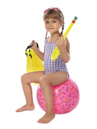 Photo of Cute little girl in swimsuit with inflatable ball and snorkeling equipment on white background