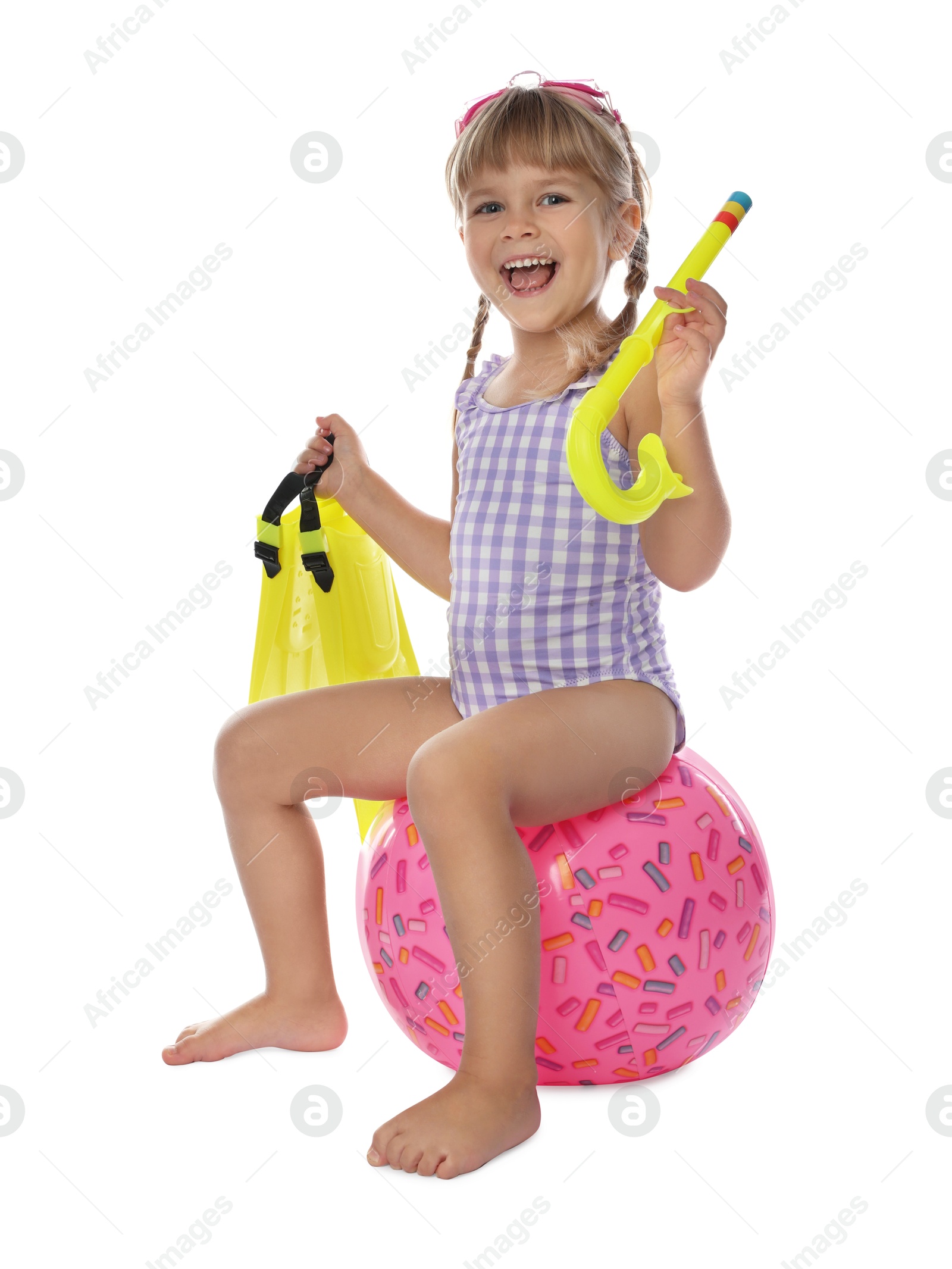 Photo of Cute little girl in swimsuit with inflatable ball and snorkeling equipment on white background