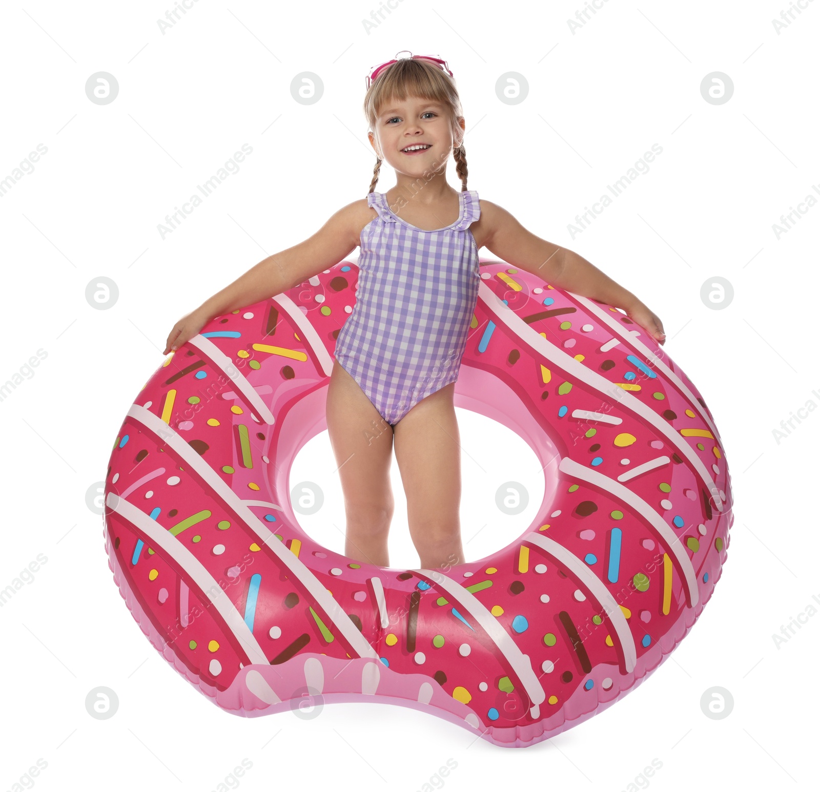 Photo of Cute little girl in swimsuit with inflatable ring and swim goggles on white background