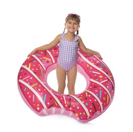 Photo of Cute little girl in swimsuit with inflatable ring and swim goggles on white background