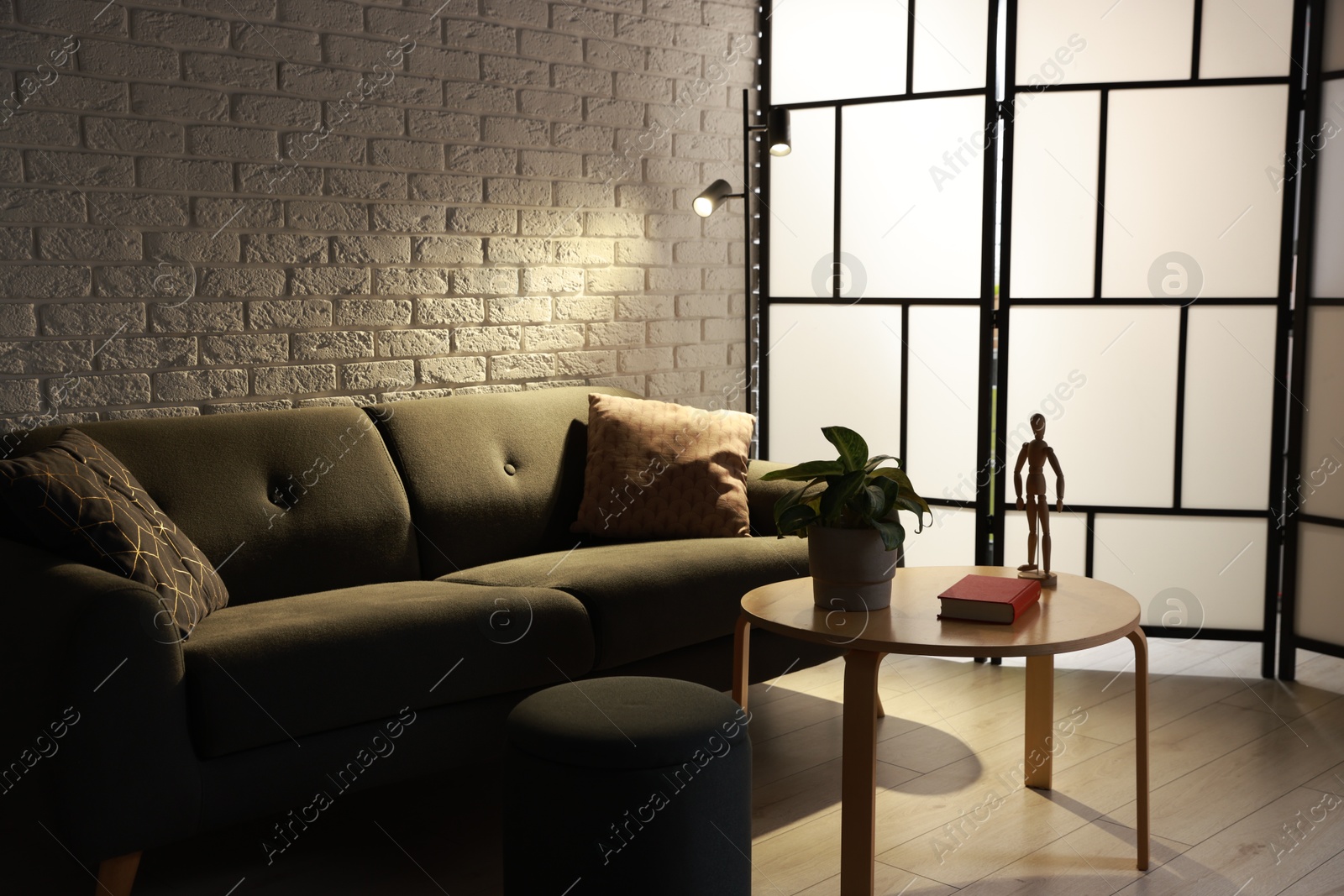 Photo of Stylish furniture, decor, lamp and houseplant in living room. Interior design