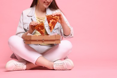 Photo of Woman with delicious pizza on pink background, closeup. Space for text