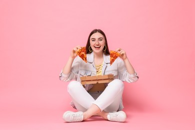 Photo of Beautiful woman with delicious pizza on pink background