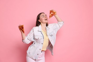 Photo of Beautiful woman with delicious pizza on pink background