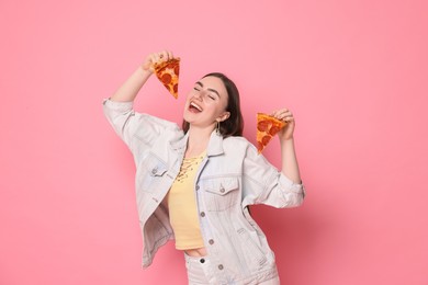 Photo of Beautiful woman with delicious pizza on pink background