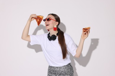 Photo of Woman in sunglasses with delicious pizza on white background