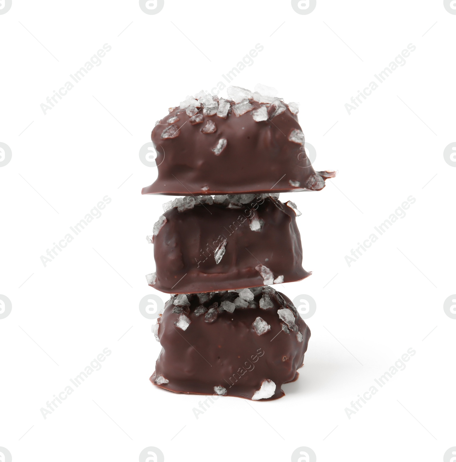 Photo of Stack of tasty chocolate candies with salt isolated on white