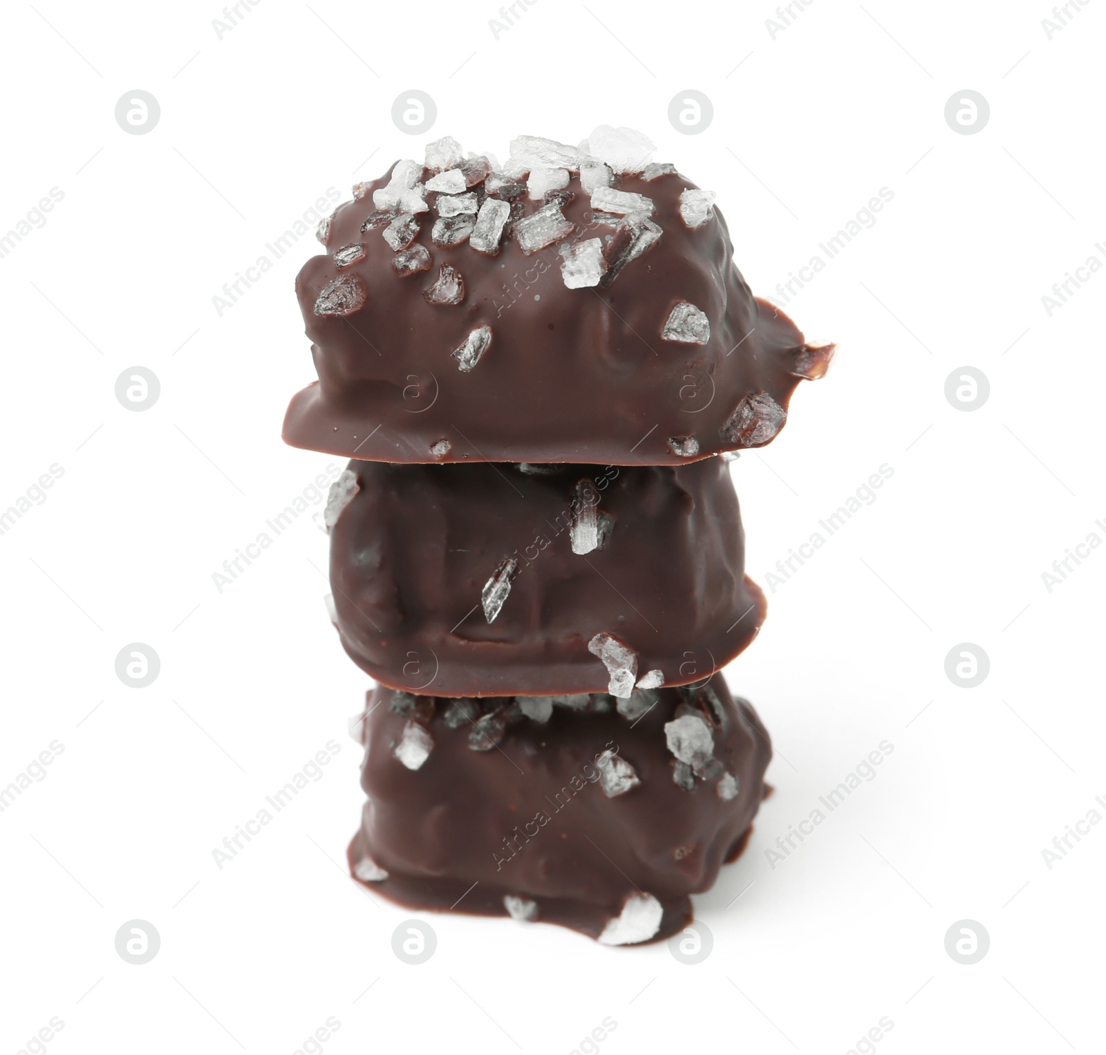 Photo of Stack of tasty chocolate candies with salt isolated on white