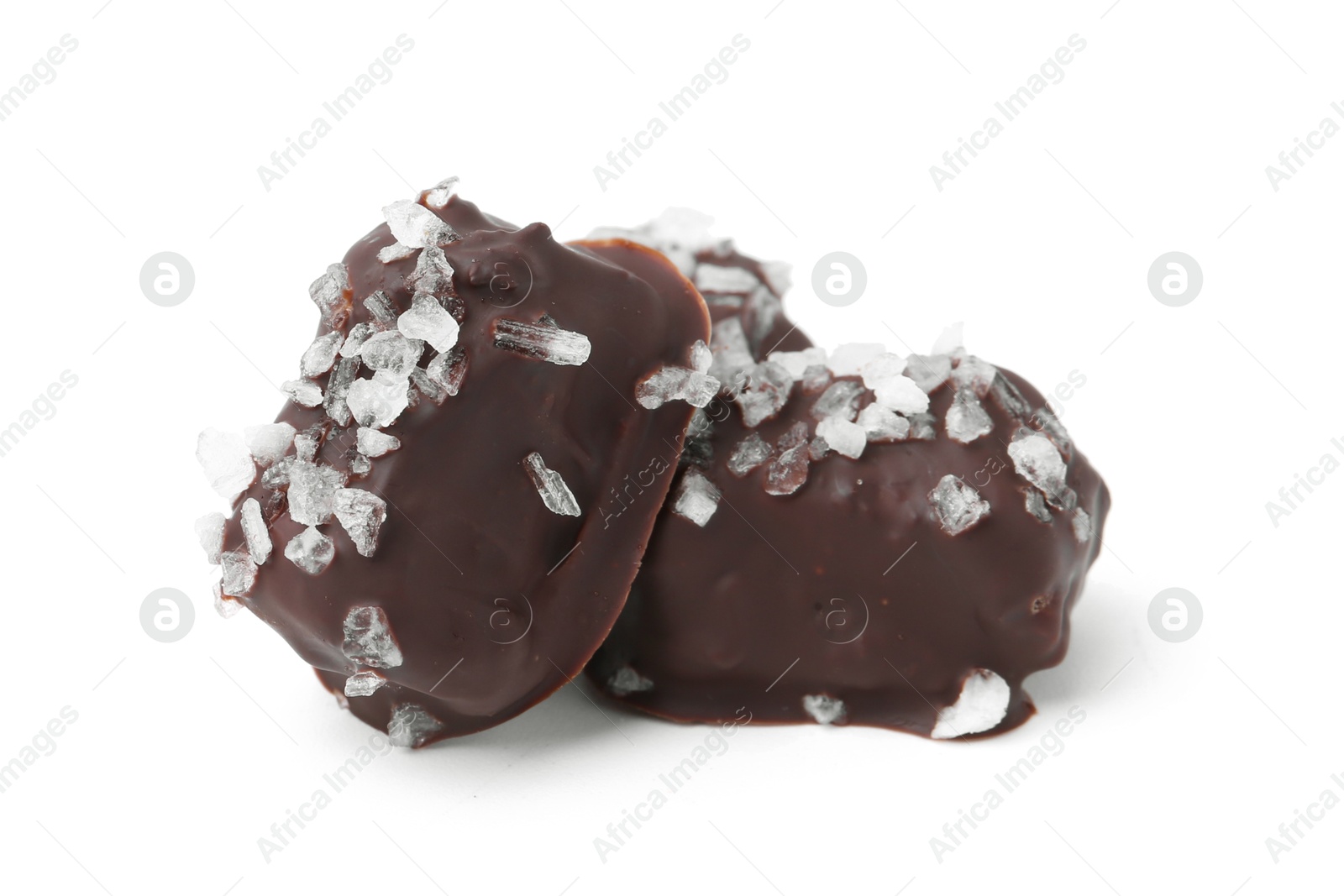 Photo of Tasty chocolate candies with salt isolated on white