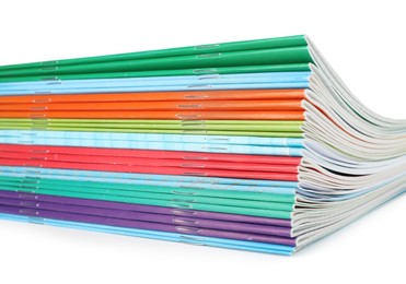 Photo of Stack of colorful copybooks isolated on white