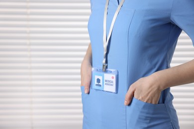 Photo of Medical assistant with badge in clinic, closeup. Space for text