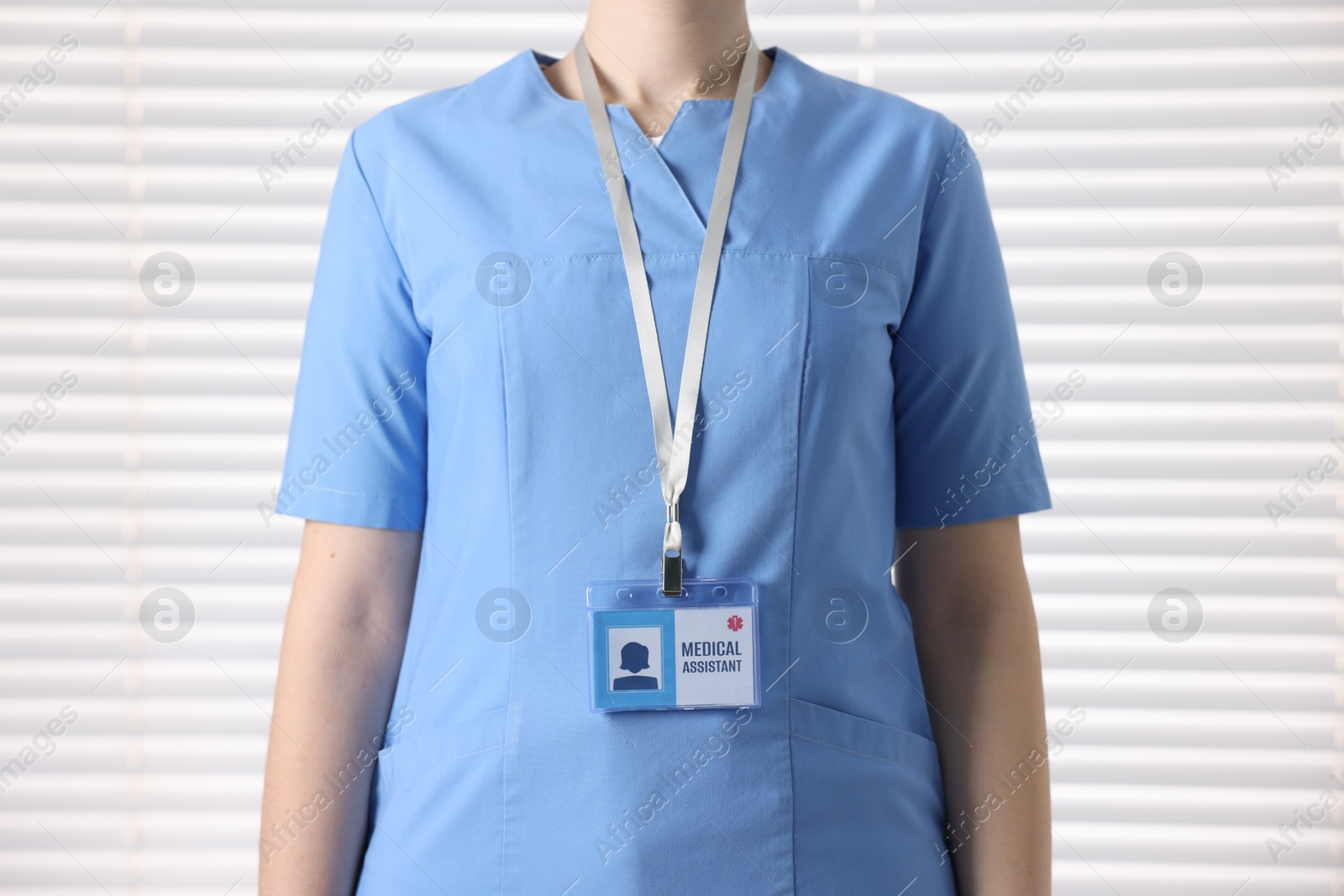 Photo of Medical assistant with badge in clinic, closeup