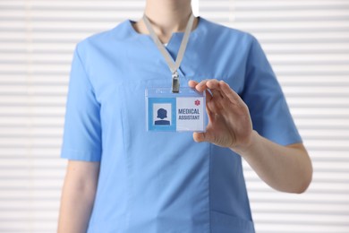 Photo of Medical assistant with badge in clinic, closeup