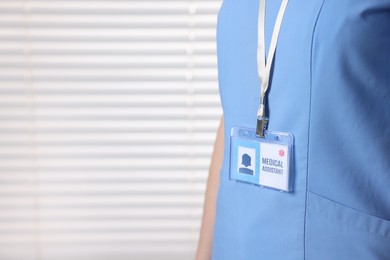 Photo of Medical assistant with badge in clinic, closeup. Space for text