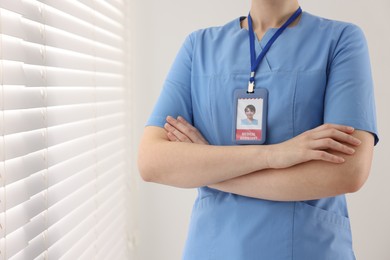 Photo of Medical assistant with badge in clinic, closeup. Space for text