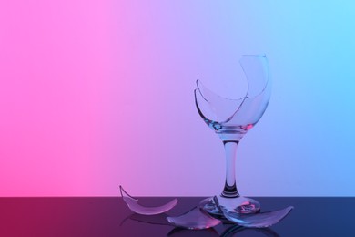 Photo of Pieces of broken wine glass on table, space for text. Color tone effect