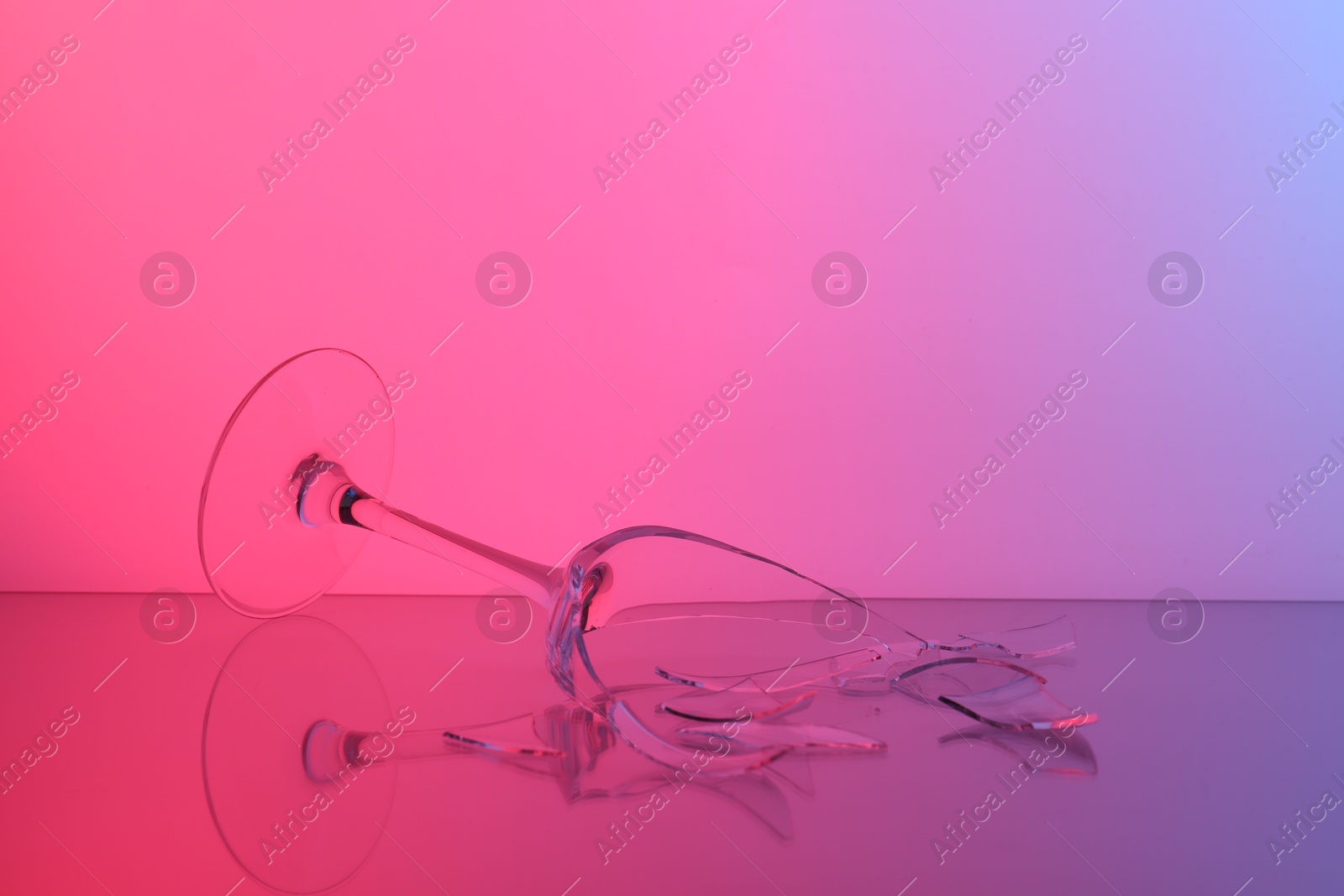 Photo of Pieces of broken wine glass on table, color tone effect